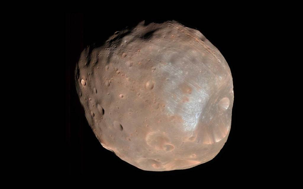 The cratered, irregular surface of Phobos against black space.